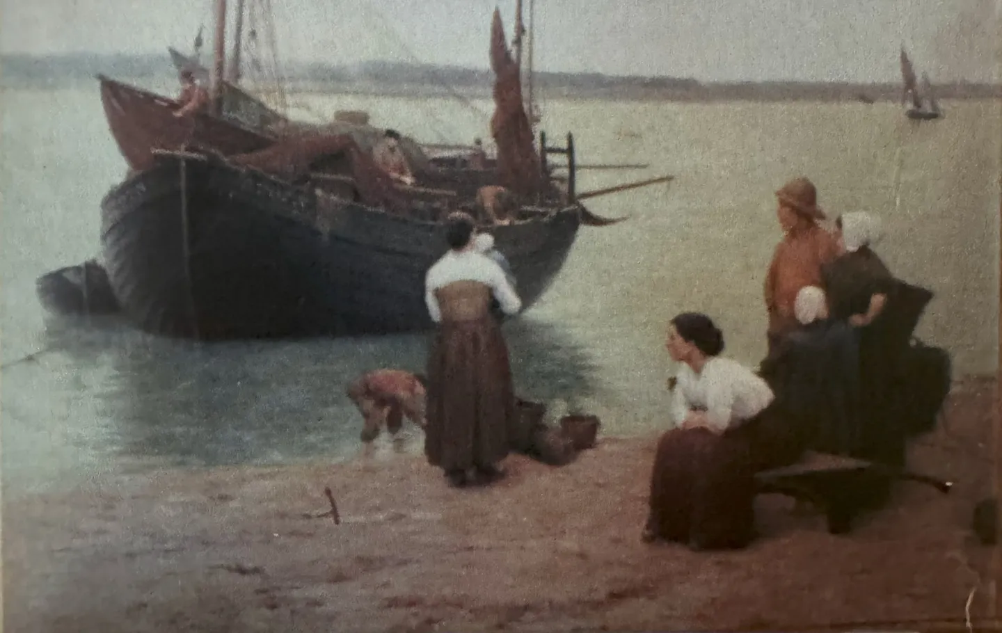 Fisherwomen wait on the shore as a fishing boat comes in