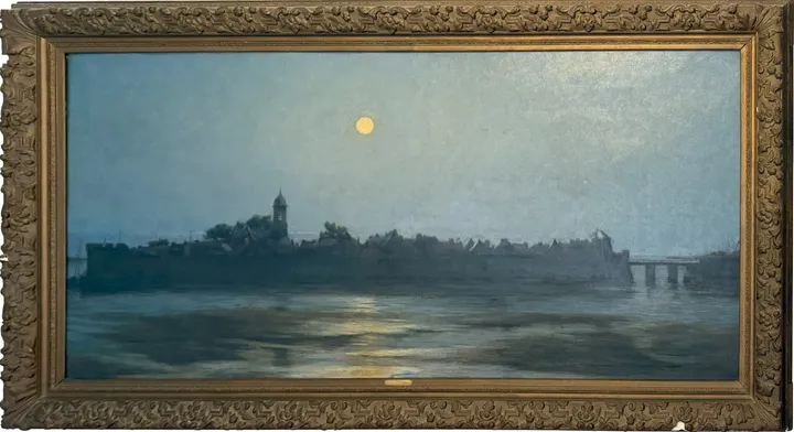 A full moon over the walled town of Concarneau, reflected in the water at dusk