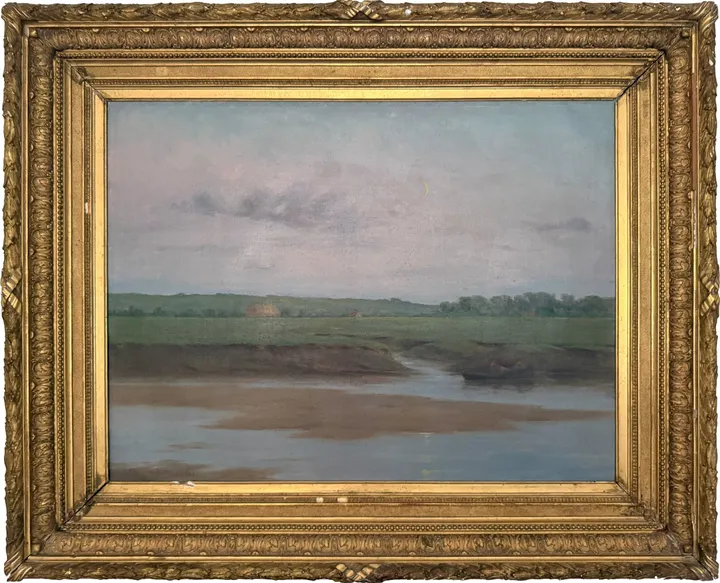A tidal creek winding through flat green marsh under a pale evening sky
