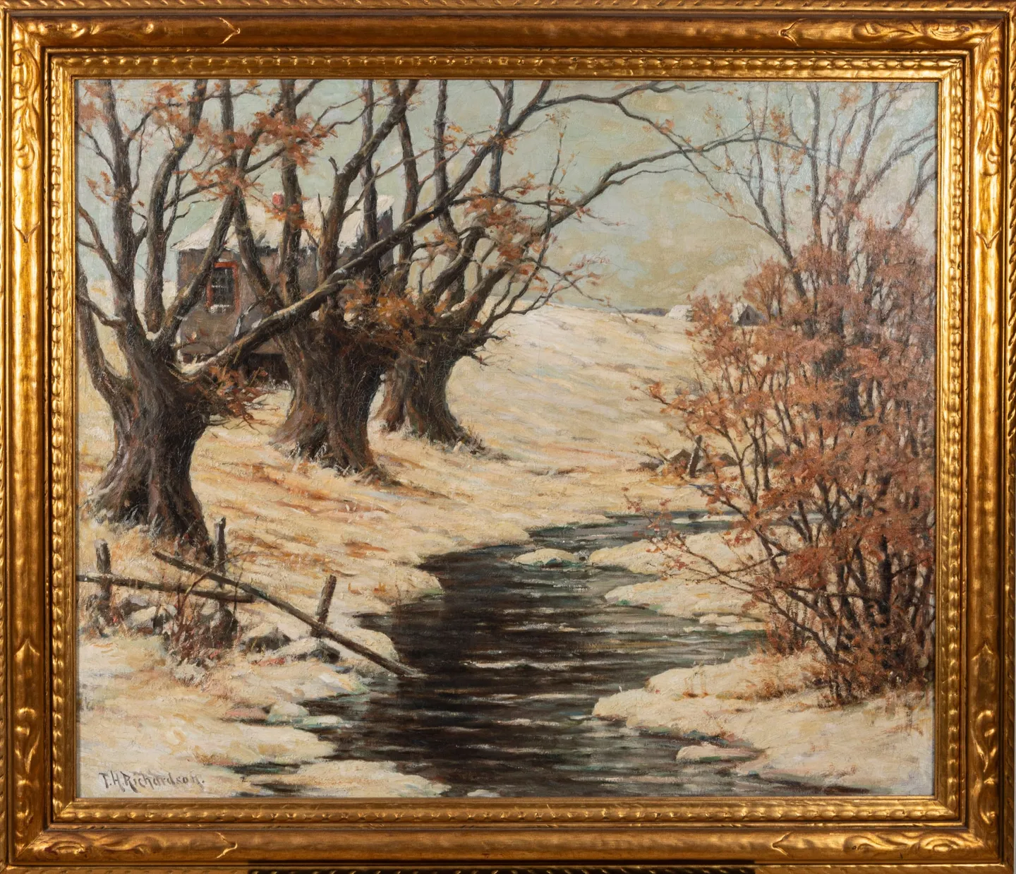 Pollarded willows and red-brown shrubs along a dark stream in snow