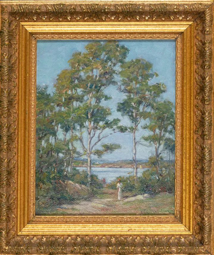 Tall trees framing a view of the water, a small figure on the path