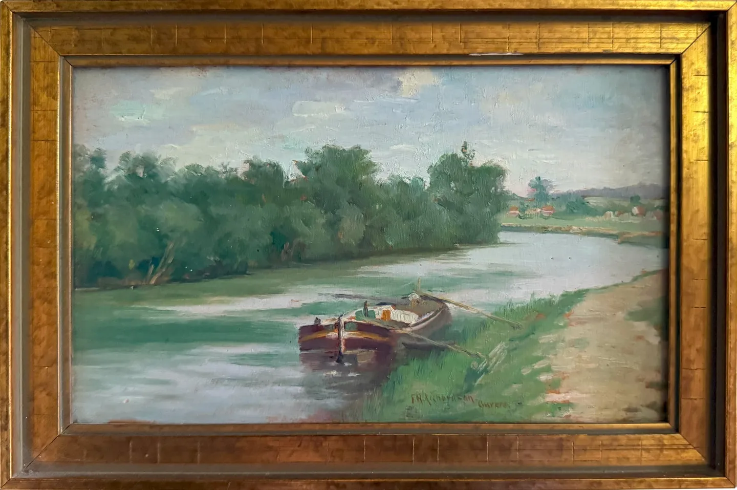 A rowboat moored at the bank of a quiet tree-lined river