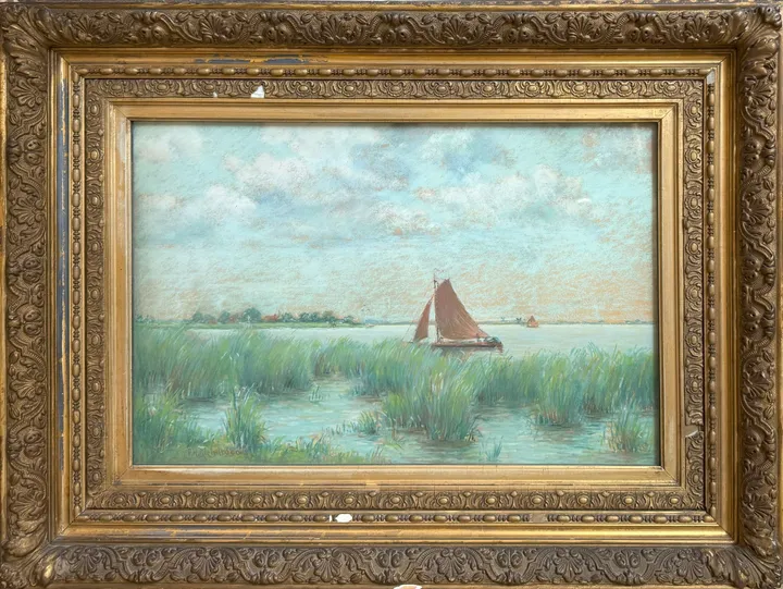 A red-sailed boat on open water beyond green reeds