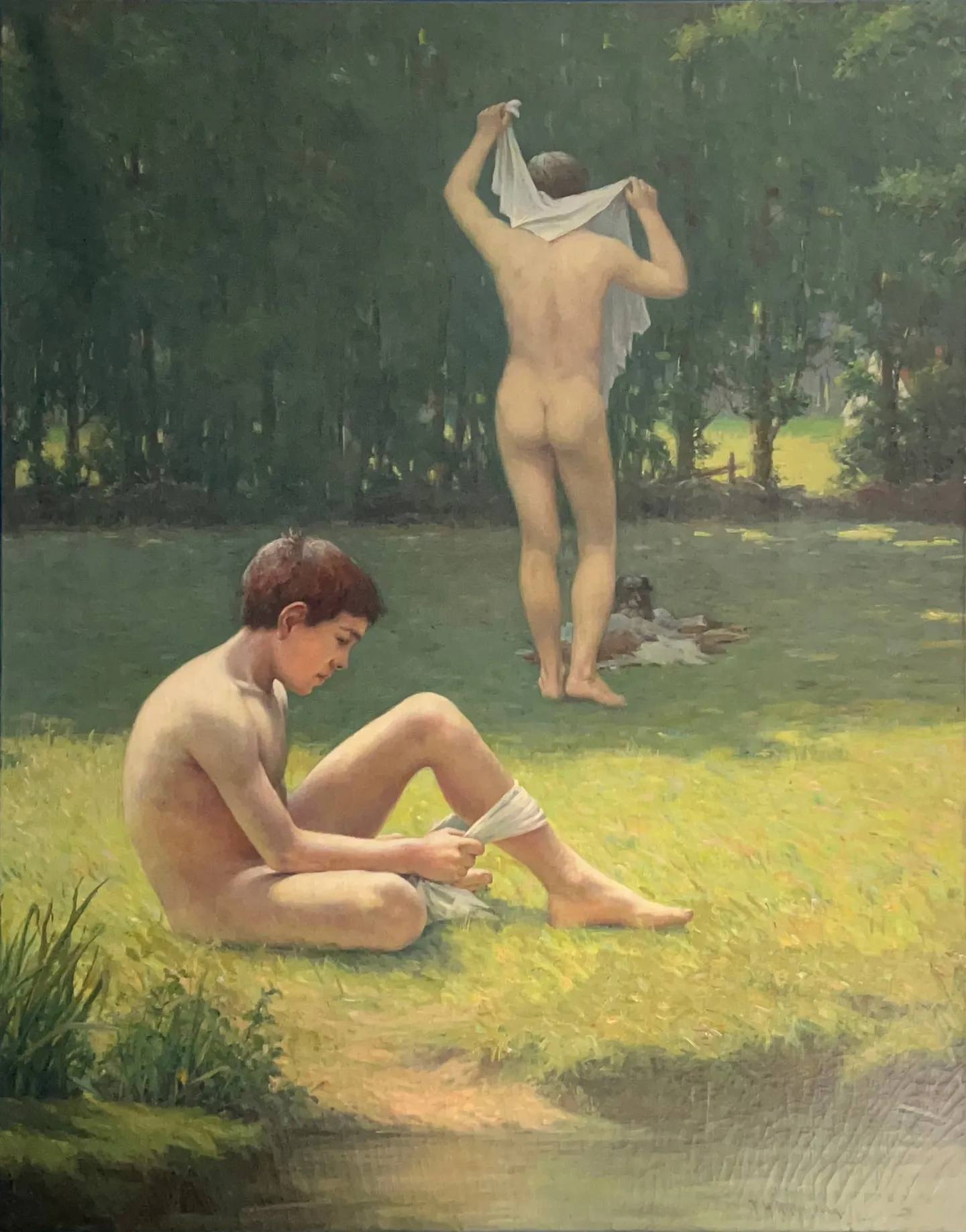 Two nude youths on a grassy riverbank, one seated, one standing and drying off