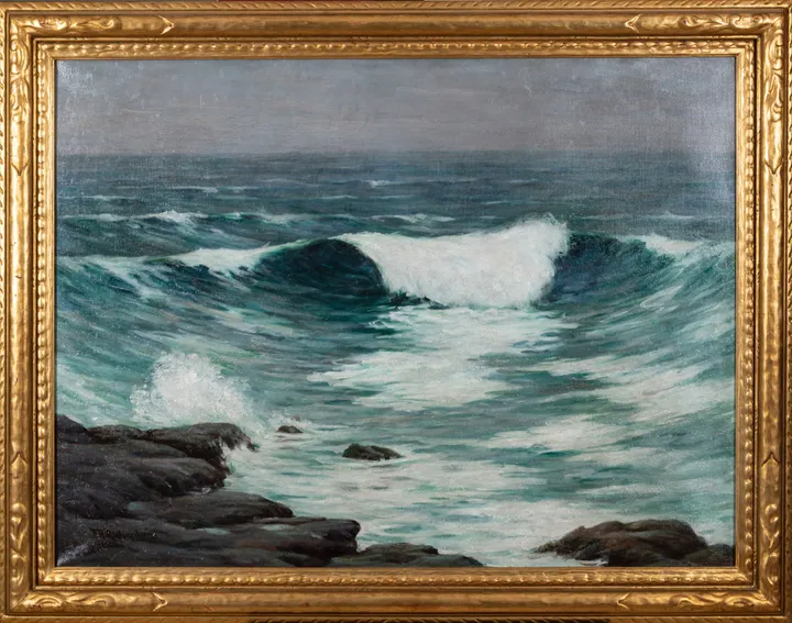 A large green wave breaking into white foam against dark rocks